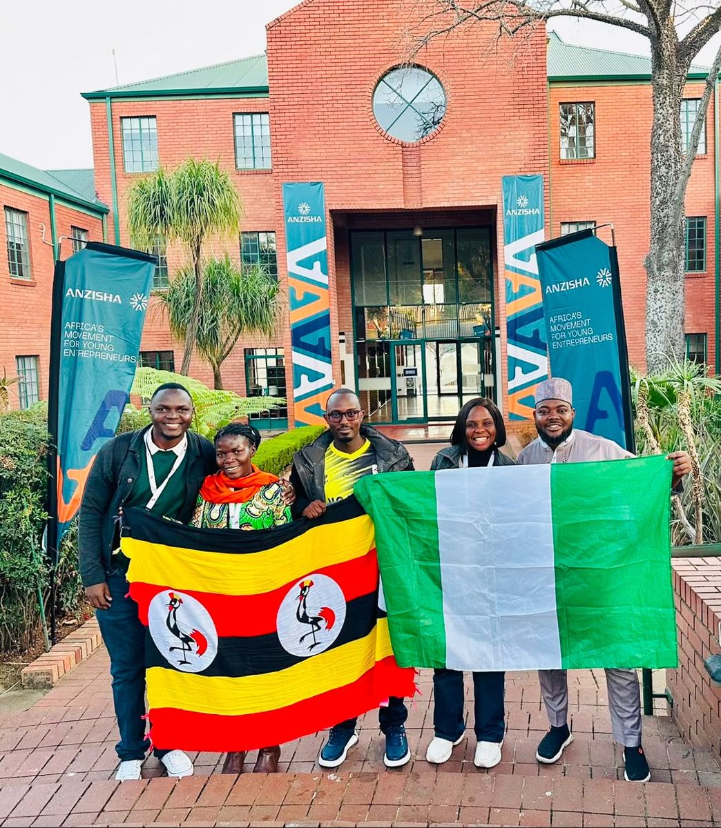 Adedolapo Osuntuyi with fellow educators holding the flags of Nigeria and Uganda at the African Leadership Academy