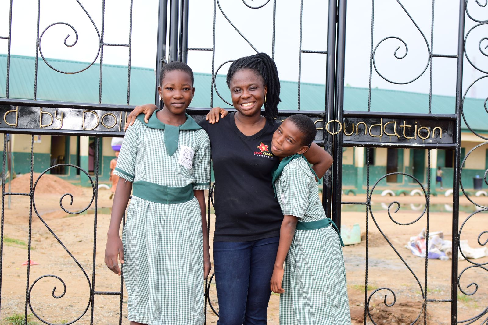 Adedolapo Osuntuyi with pupils at the new school gate
